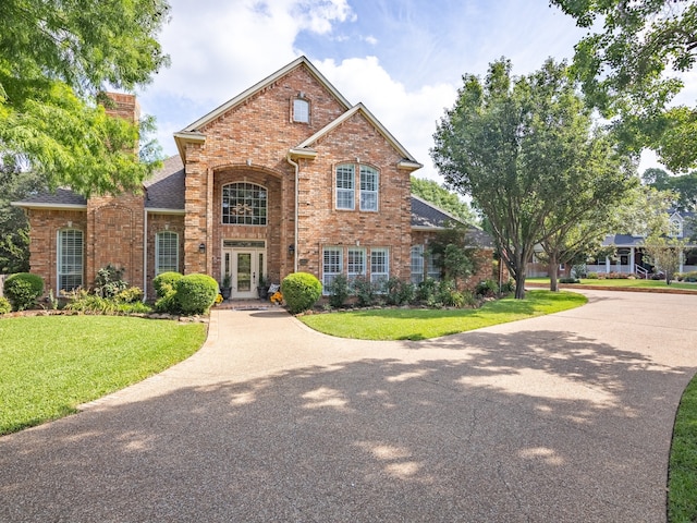 view of front property featuring a front yard and french doors