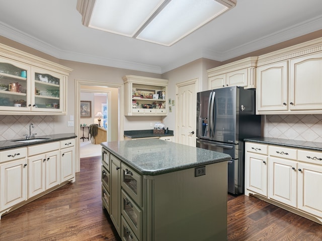 kitchen with a center island, dark hardwood / wood-style floors, sink, cream cabinets, and stainless steel fridge with ice dispenser