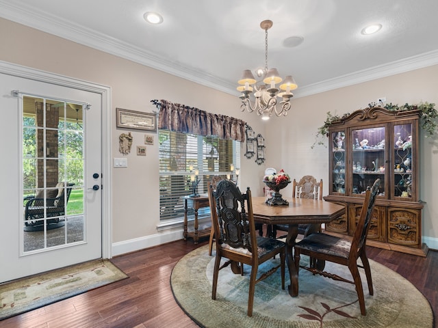 dining area with crown molding, dark hardwood / wood-style flooring, and a chandelier