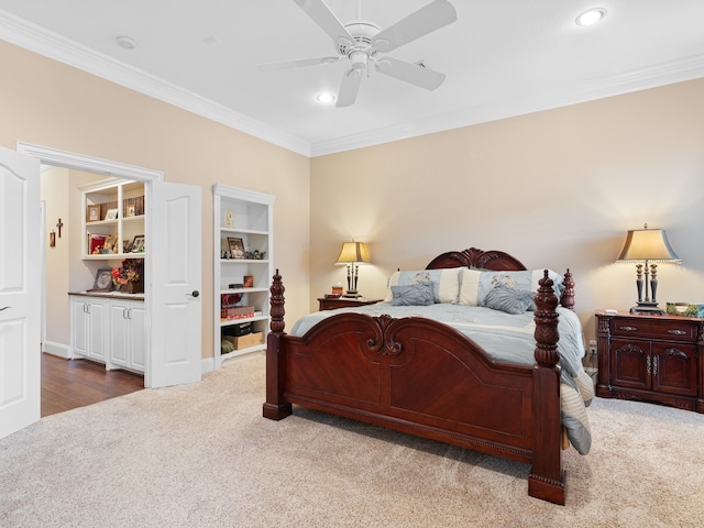 carpeted bedroom featuring ornamental molding and ceiling fan