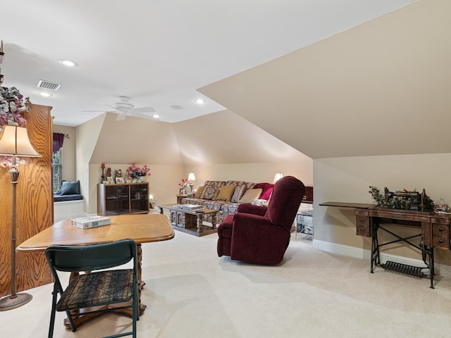 living room with ceiling fan, vaulted ceiling, and light carpet