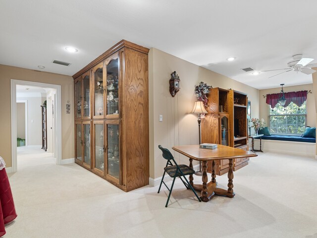 carpeted dining area featuring ceiling fan