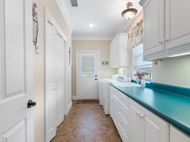 kitchen with ornamental molding, white cabinets, and washer and clothes dryer