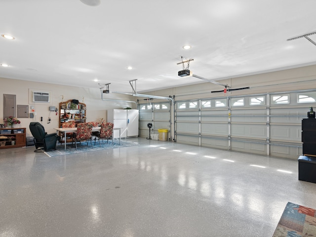 garage featuring a garage door opener and white fridge