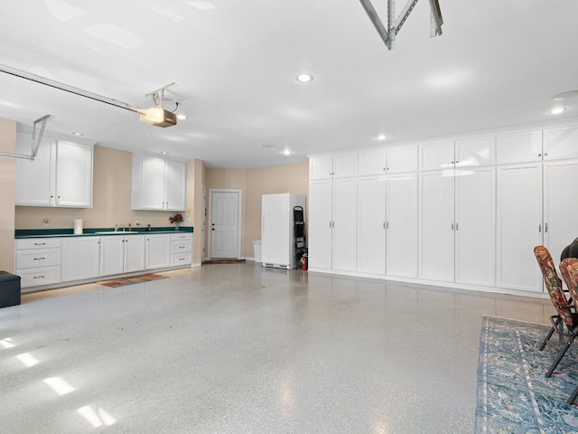 garage featuring a garage door opener and white refrigerator