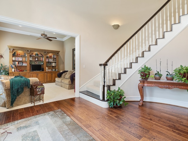 interior space featuring ceiling fan, ornamental molding, and hardwood / wood-style floors