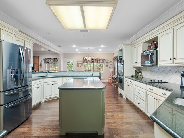 kitchen with a center island, dark hardwood / wood-style floors, cream cabinetry, and black appliances