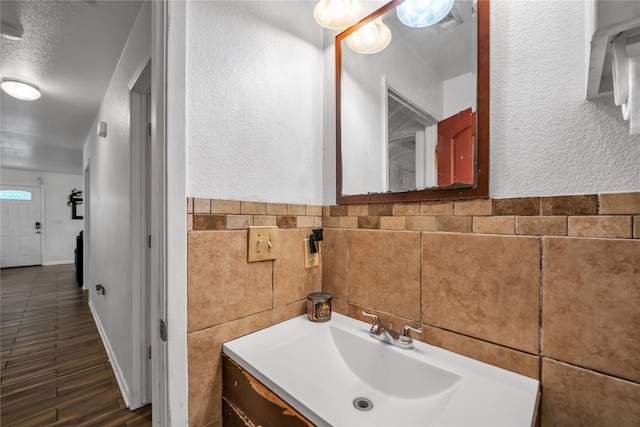 bathroom with tile walls and vanity