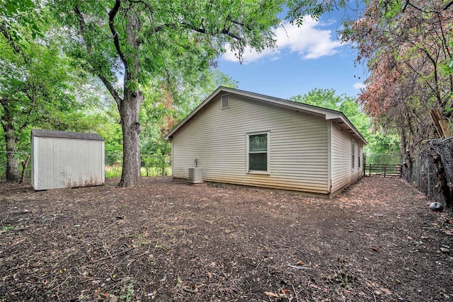 view of property exterior featuring a shed and cooling unit