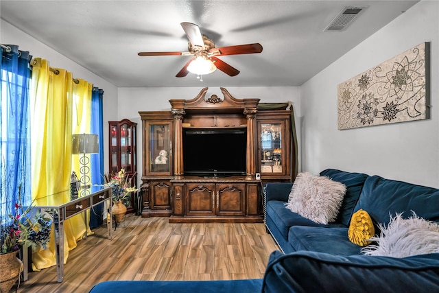 living room featuring ceiling fan and wood-type flooring