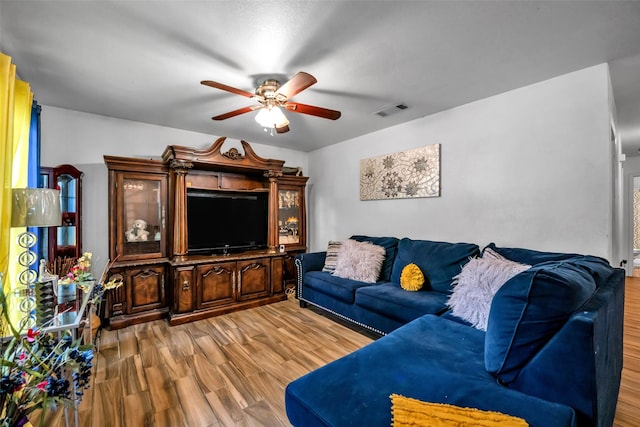 living room featuring hardwood / wood-style flooring and ceiling fan