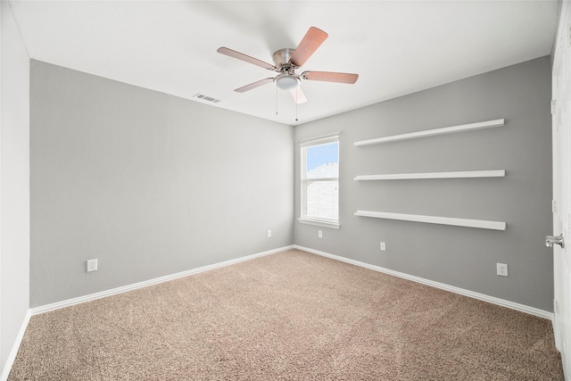 carpeted spare room featuring ceiling fan