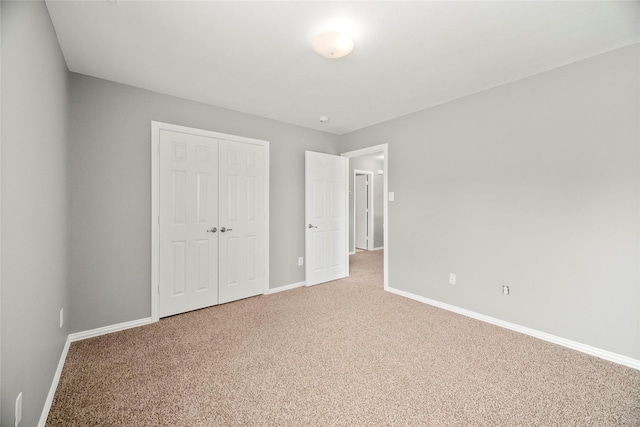 unfurnished bedroom featuring a closet and carpet