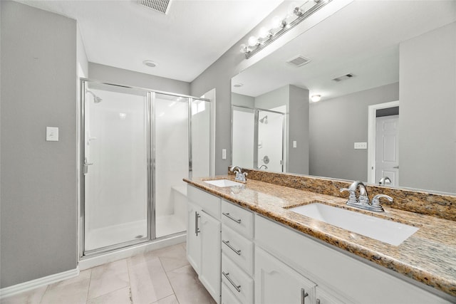 bathroom featuring vanity, tile patterned floors, and a shower with door