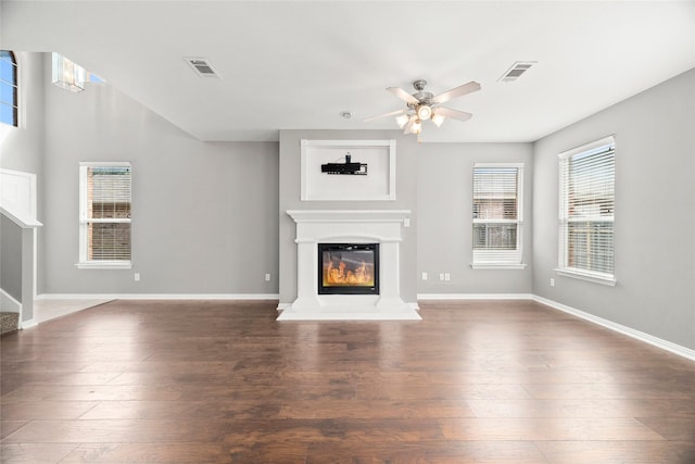 unfurnished living room with ceiling fan and dark hardwood / wood-style floors