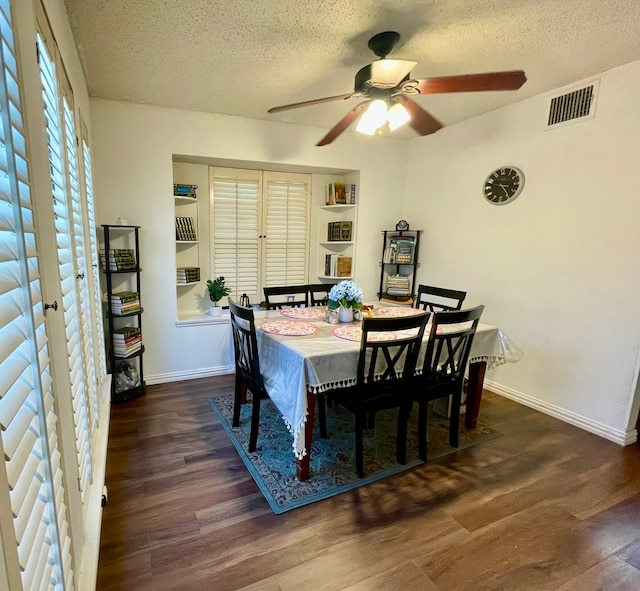 dining area with a textured ceiling, dark hardwood / wood-style floors, and ceiling fan