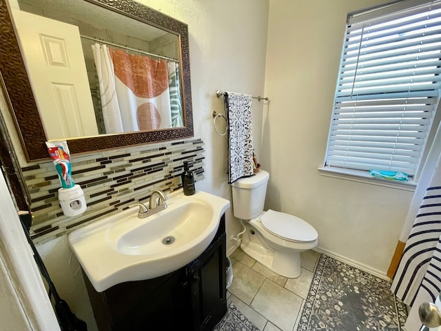 bathroom featuring vanity, tile patterned floors, a shower with curtain, decorative backsplash, and toilet