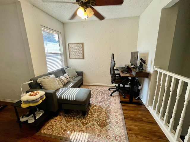 office space featuring a textured ceiling, ceiling fan, and dark wood-type flooring