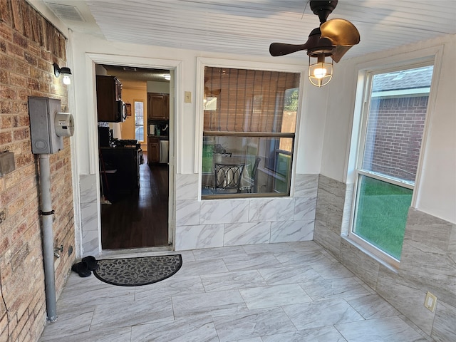 doorway to property featuring ceiling fan