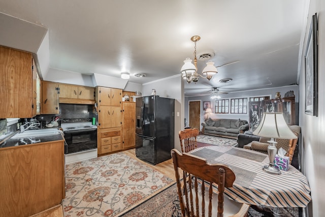 kitchen with light hardwood / wood-style floors, black fridge with ice dispenser, sink, decorative backsplash, and white electric range oven