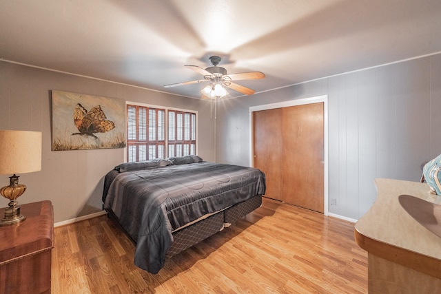 bedroom with wood-type flooring, a closet, and ceiling fan