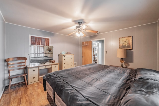 bedroom with light hardwood / wood-style flooring and ceiling fan