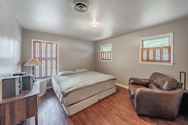 bedroom with dark wood-type flooring