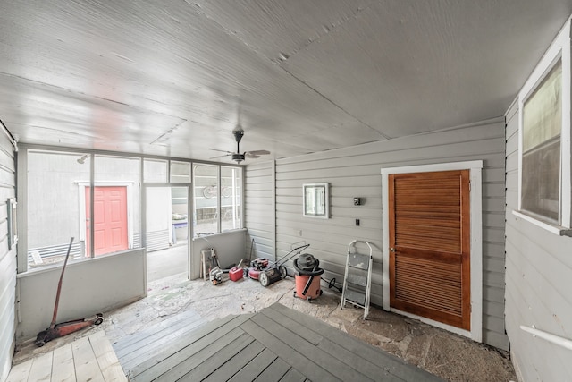 unfurnished sunroom with ceiling fan