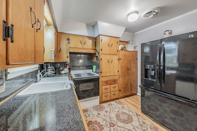 kitchen with black fridge, ornamental molding, sink, white range with electric cooktop, and light hardwood / wood-style floors