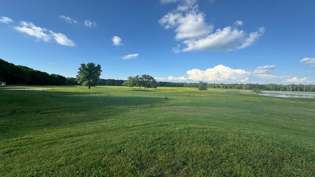 view of home's community featuring a lawn and a rural view