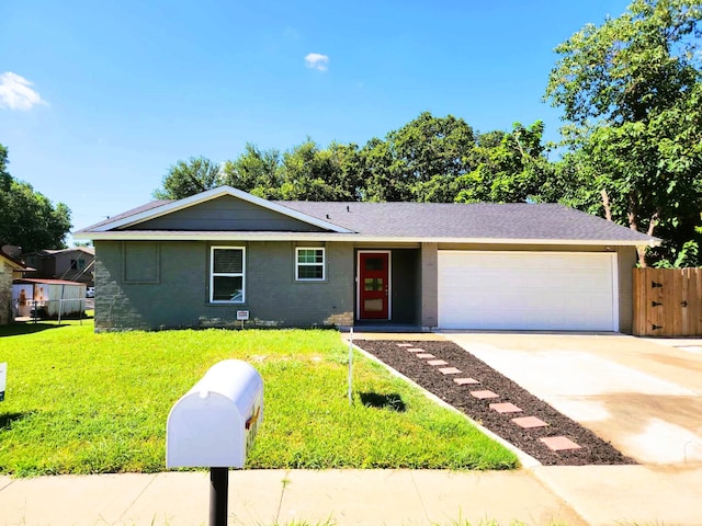 single story home featuring a garage and a front lawn