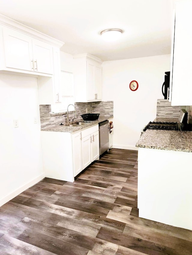 kitchen with stainless steel appliances, light stone counters, dark hardwood / wood-style flooring, backsplash, and white cabinets