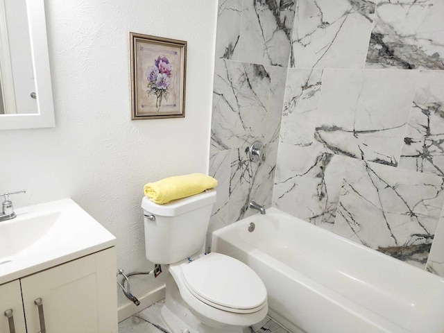 full bathroom with tiled shower / bath, vanity, and toilet