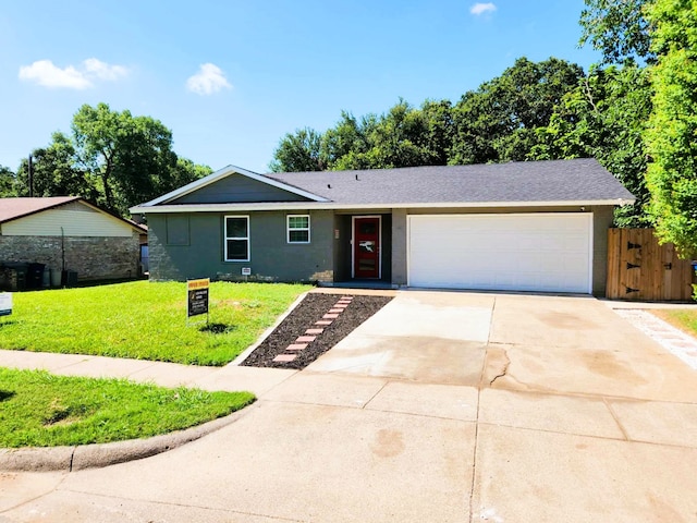 ranch-style home with a front yard and a garage