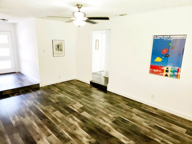 spare room with ceiling fan and dark hardwood / wood-style flooring