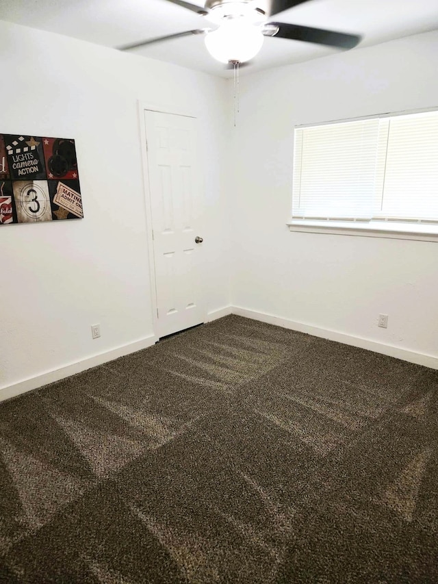 empty room featuring carpet flooring and ceiling fan