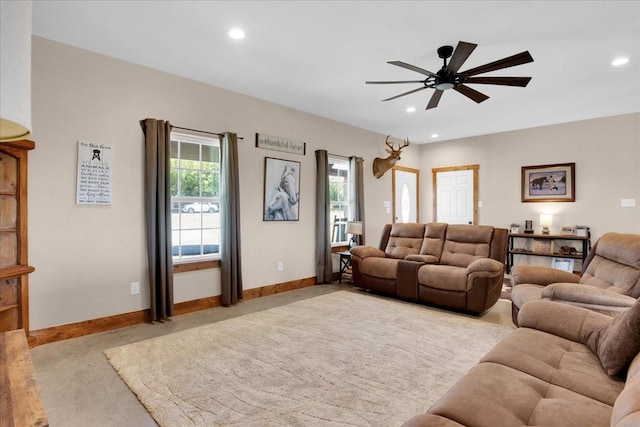 living area featuring baseboards, light carpet, a ceiling fan, and recessed lighting