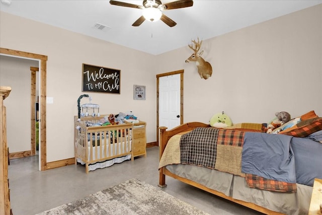 bedroom featuring visible vents, finished concrete floors, baseboards, and ceiling fan