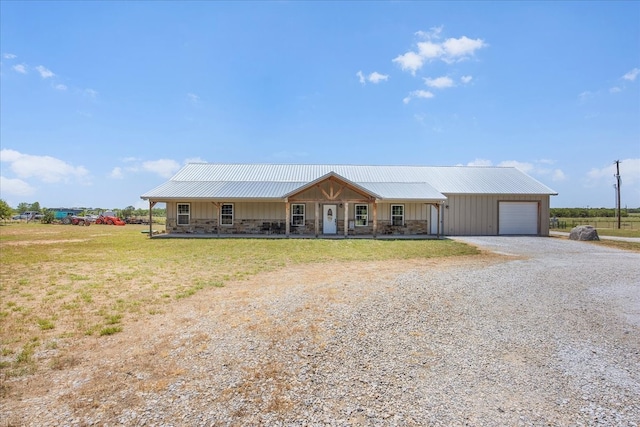 ranch-style home with a garage, a porch, and a front lawn