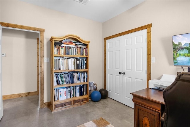 home office featuring visible vents, concrete floors, and baseboards