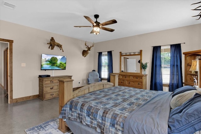 bedroom with ceiling fan, multiple windows, visible vents, and baseboards