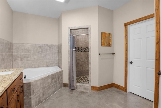 bathroom featuring a garden tub, a tile shower, vanity, and baseboards