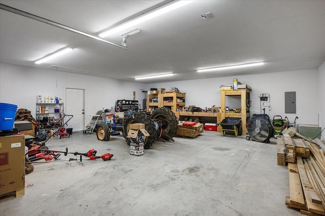 garage with electric panel and a workshop area