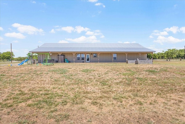 view of front facade featuring a playground and a front yard