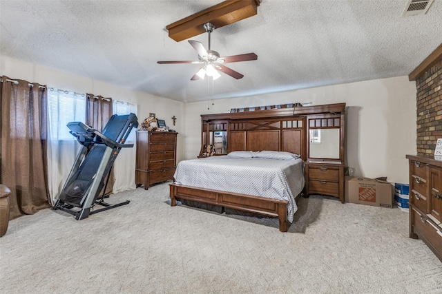 bedroom with a ceiling fan, carpet, visible vents, and a textured ceiling