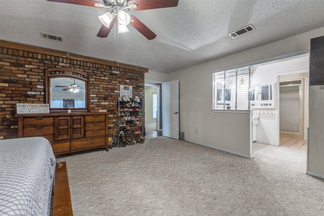 bedroom featuring light carpet, baseboards, visible vents, and a textured ceiling