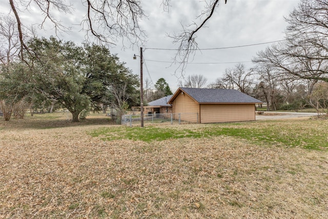 view of side of property with a lawn and fence