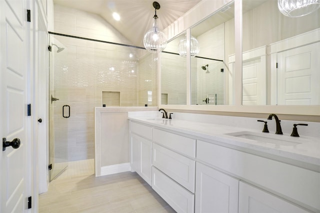 bathroom with walk in shower, lofted ceiling, and vanity