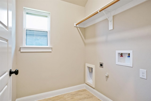 clothes washing area featuring electric dryer hookup, hookup for a washing machine, hookup for a gas dryer, and light hardwood / wood-style floors