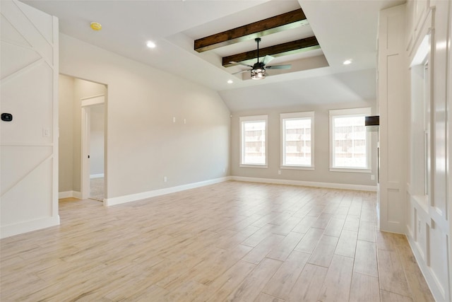 spare room featuring beamed ceiling, ceiling fan, and light wood-type flooring